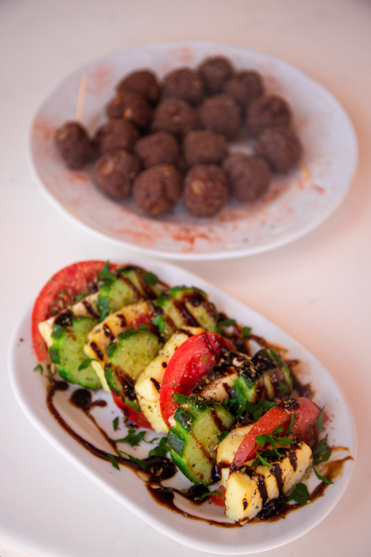 plate of haloumi, tomatoes and cucumber and meatballs