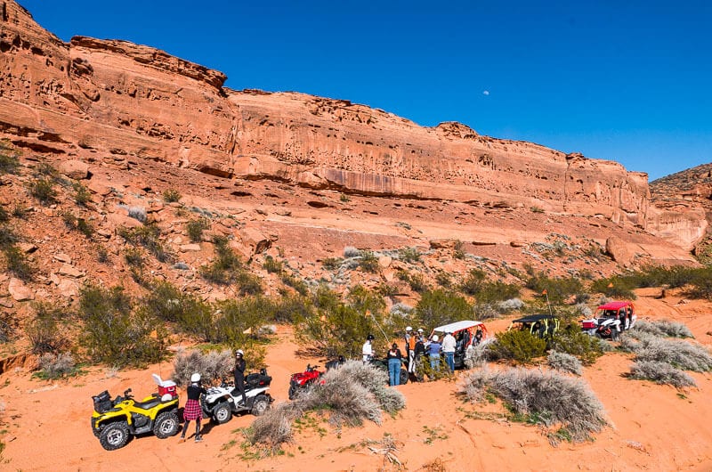 a row of ATV's parked in the desert