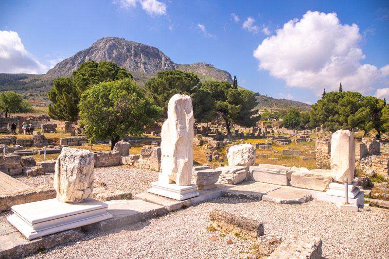 white stunted colums on the bera of st paul with acrocorinth acropolis behind