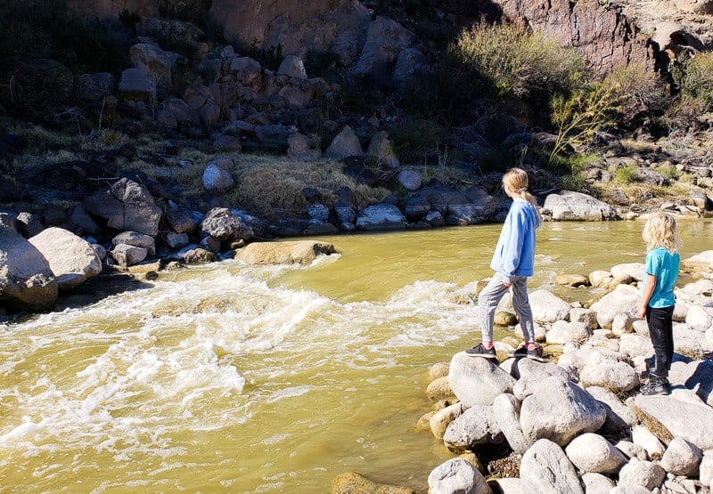 girl standing next to a river