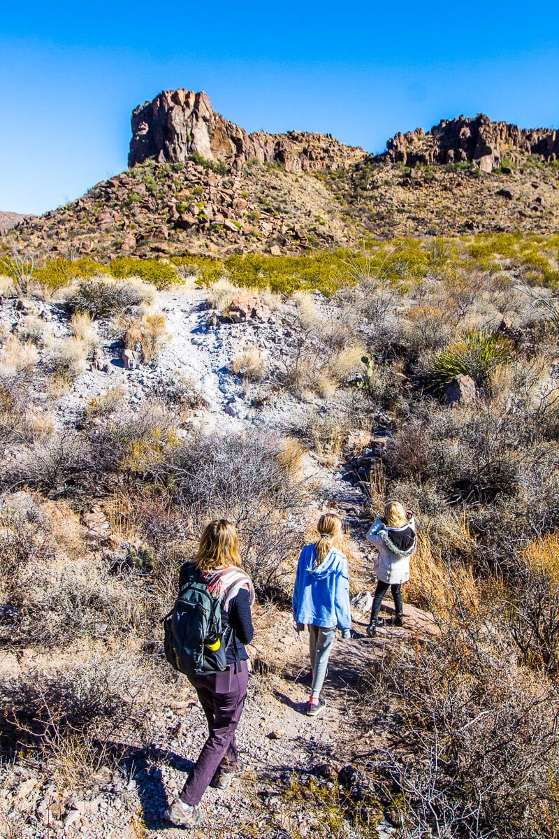 girls hiking on the Ojito Andentro trail past a mountain