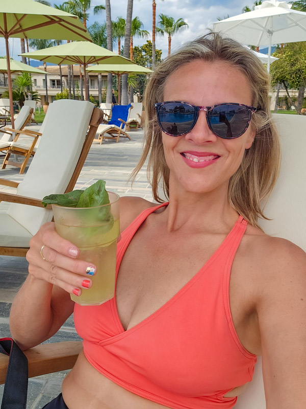 caz enjoying a cocktail beside the pool