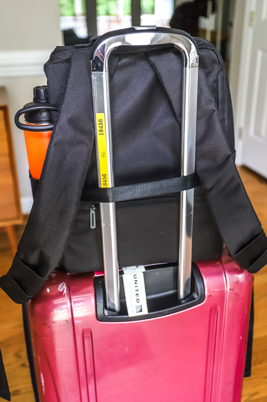 daypack strapped to suitcase