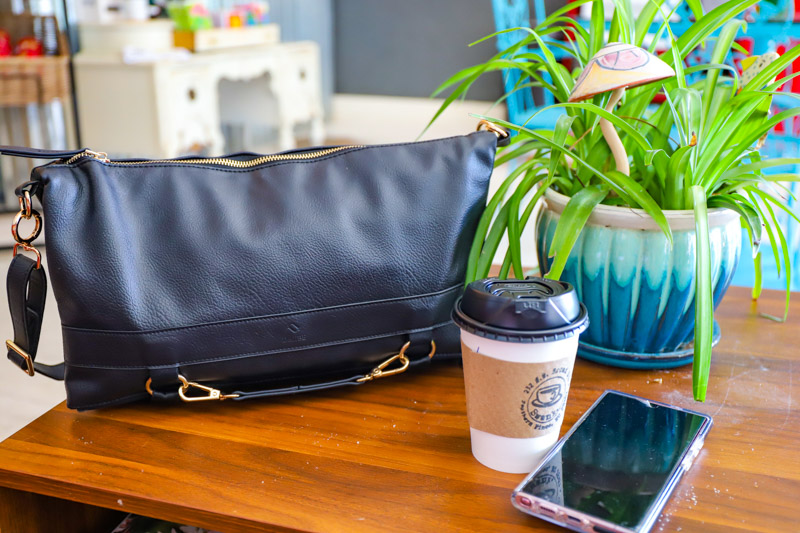 driibe handbag on table with coffee