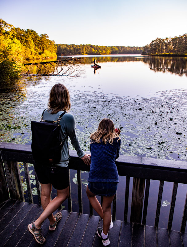 woman and child looking at view of lake