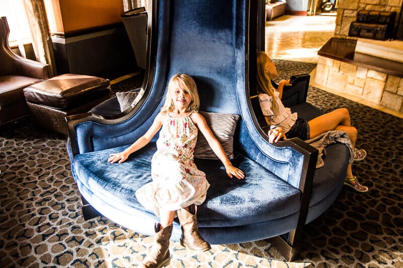 Savannah sitting on blue chari in hotel lobby