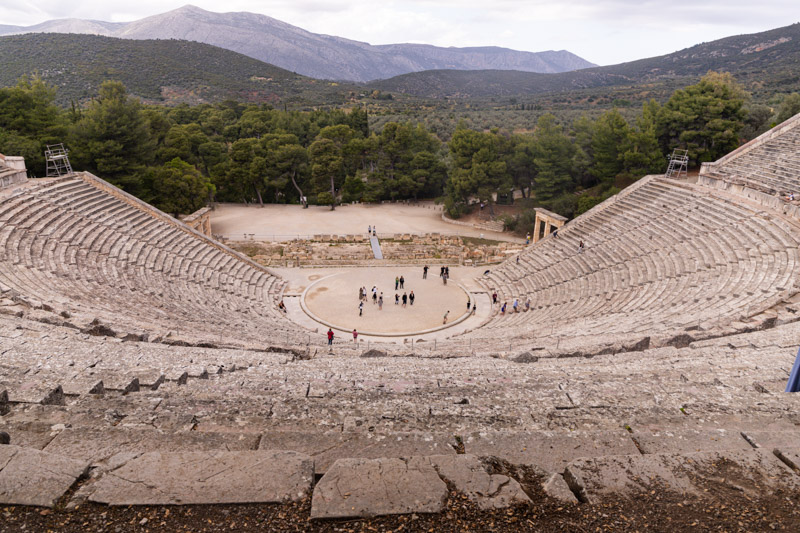 ancient theater of Epidaurus with mountains in the background