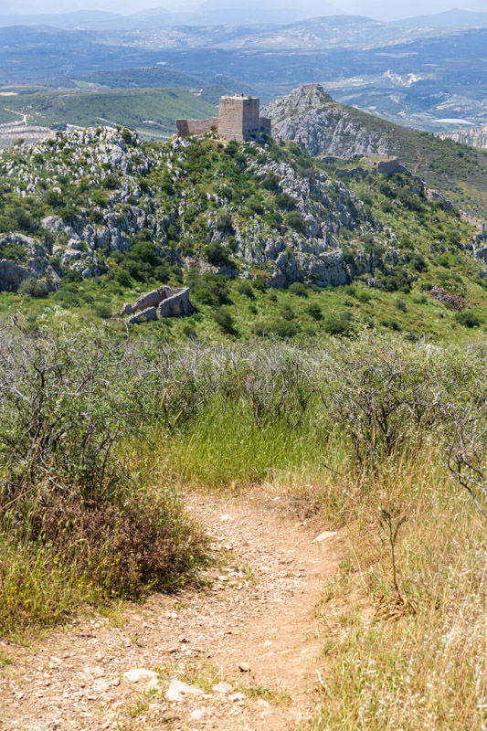 frankish tower in the distance with rolling hills in the foreground