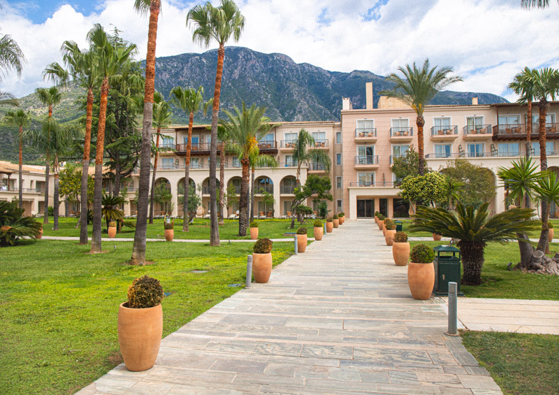 courtyard surrounded by resort buildings and palm trees