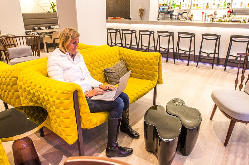 woman sitting on a couch using a computer 