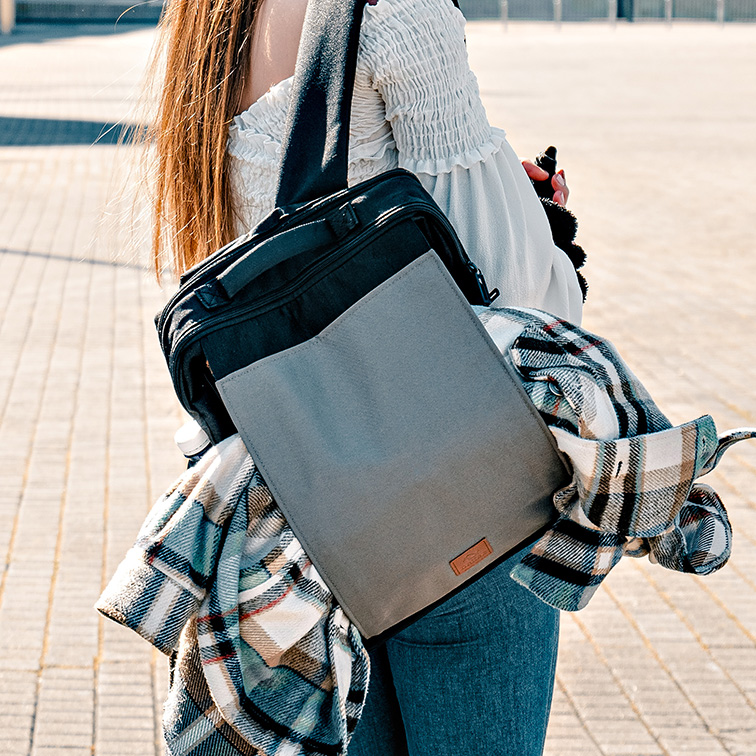 girl carrying backpack with jacket 