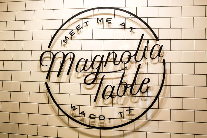 Magnolia Table sign on subway tiled wall