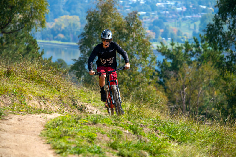 person riding bike on mountain trail