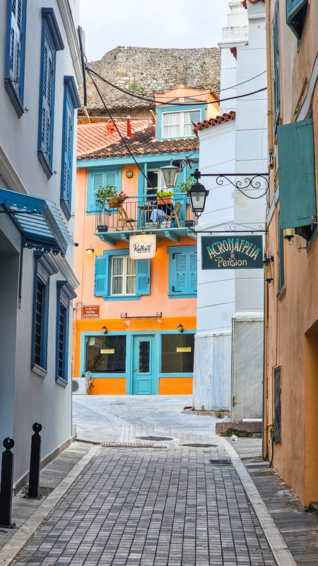 stone covered alley  of nafplio  with colorful buildings