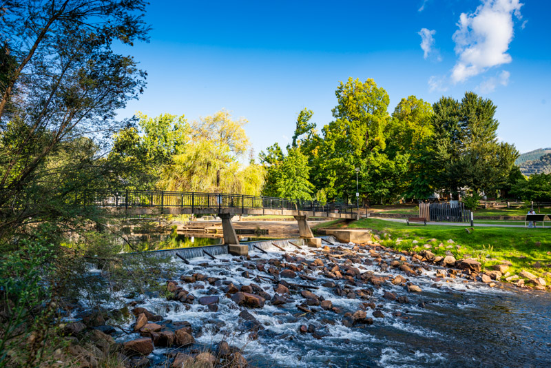 Ovens river bubbling over rocks beside the bridge