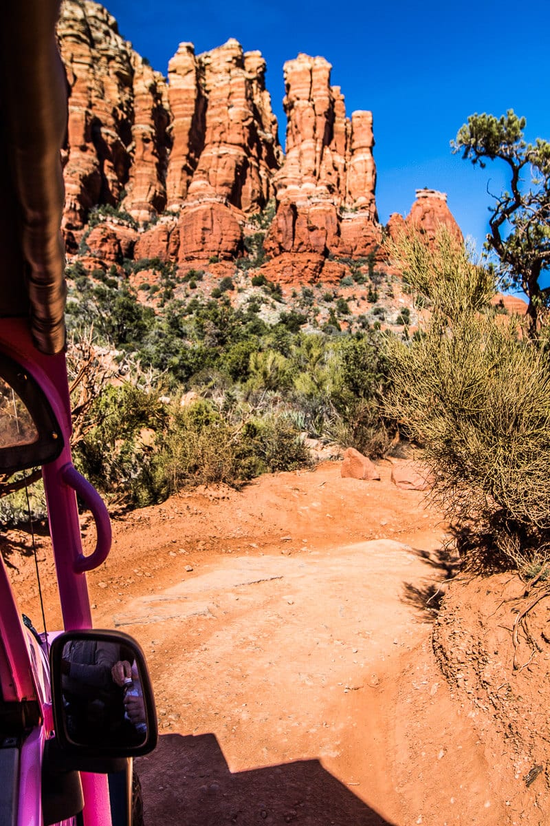 Pink Jeep driving down red track