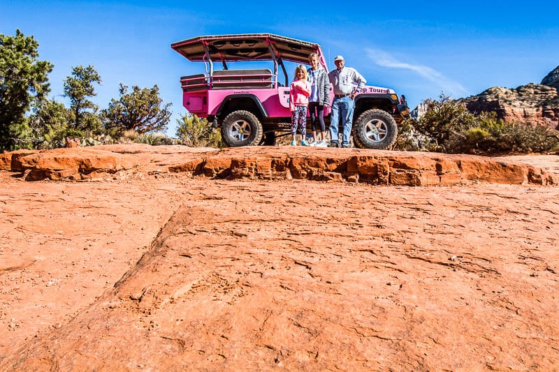 family standing in front of Pink Jeep 