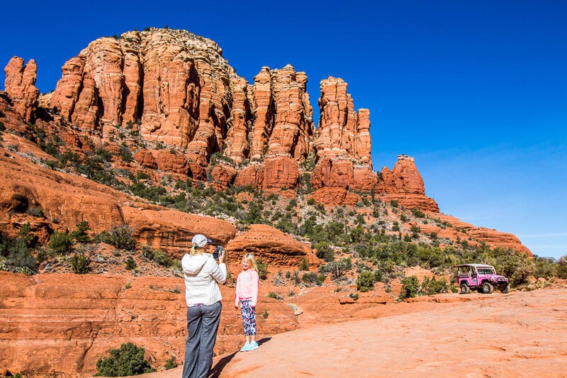 caroline taking a photo of savannah on red rocks of sedona