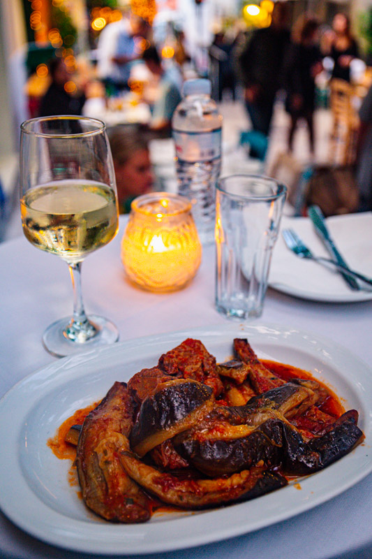 lamb on plate with glass of wine