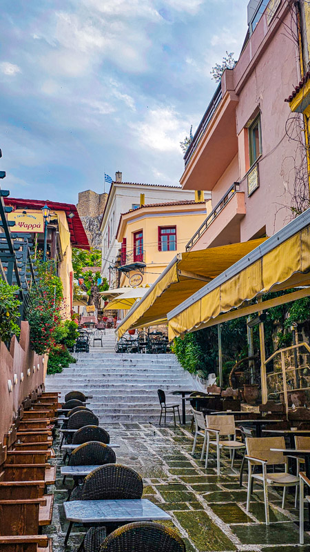 colorful buildings on either side of stairs