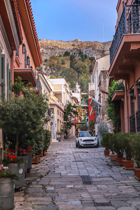 car down narrow cobblestone street in plaka