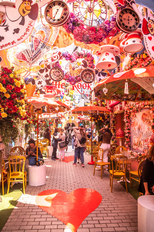 decorations drooping form the ceilings and walls in the little klook alleyway