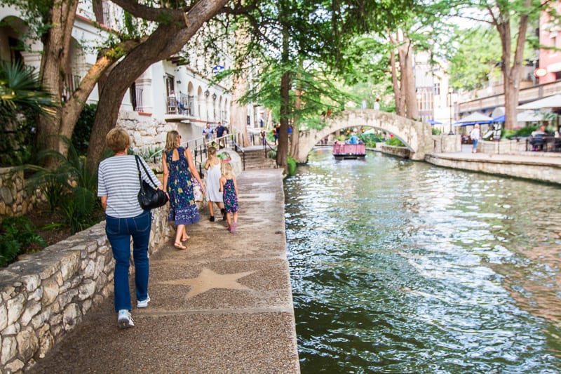 people walking along a river