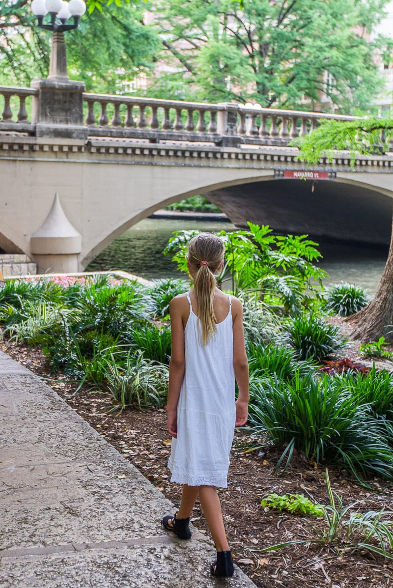 girl walking along a river