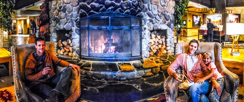 family sitting by fire in tenaya lodge lobby