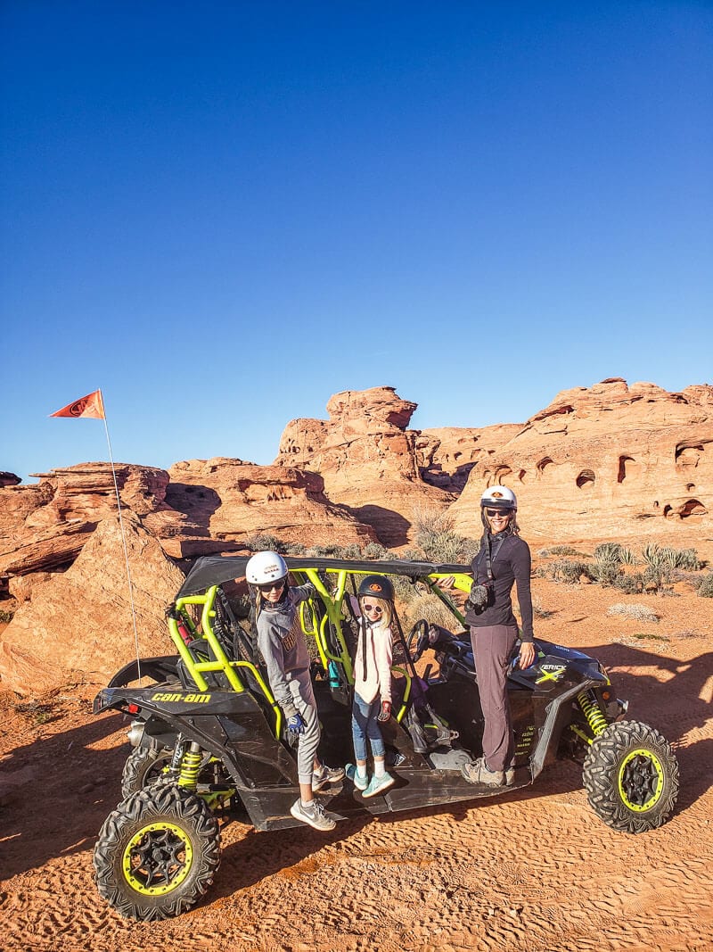 family standing on ATV posing