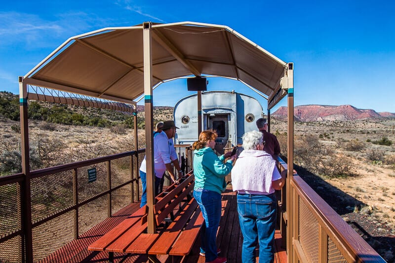 people standing on an outside train