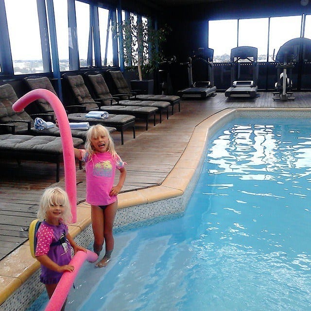 girls standing on pool steps