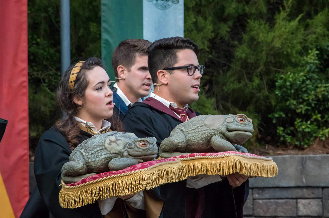 People holding frogs and singning