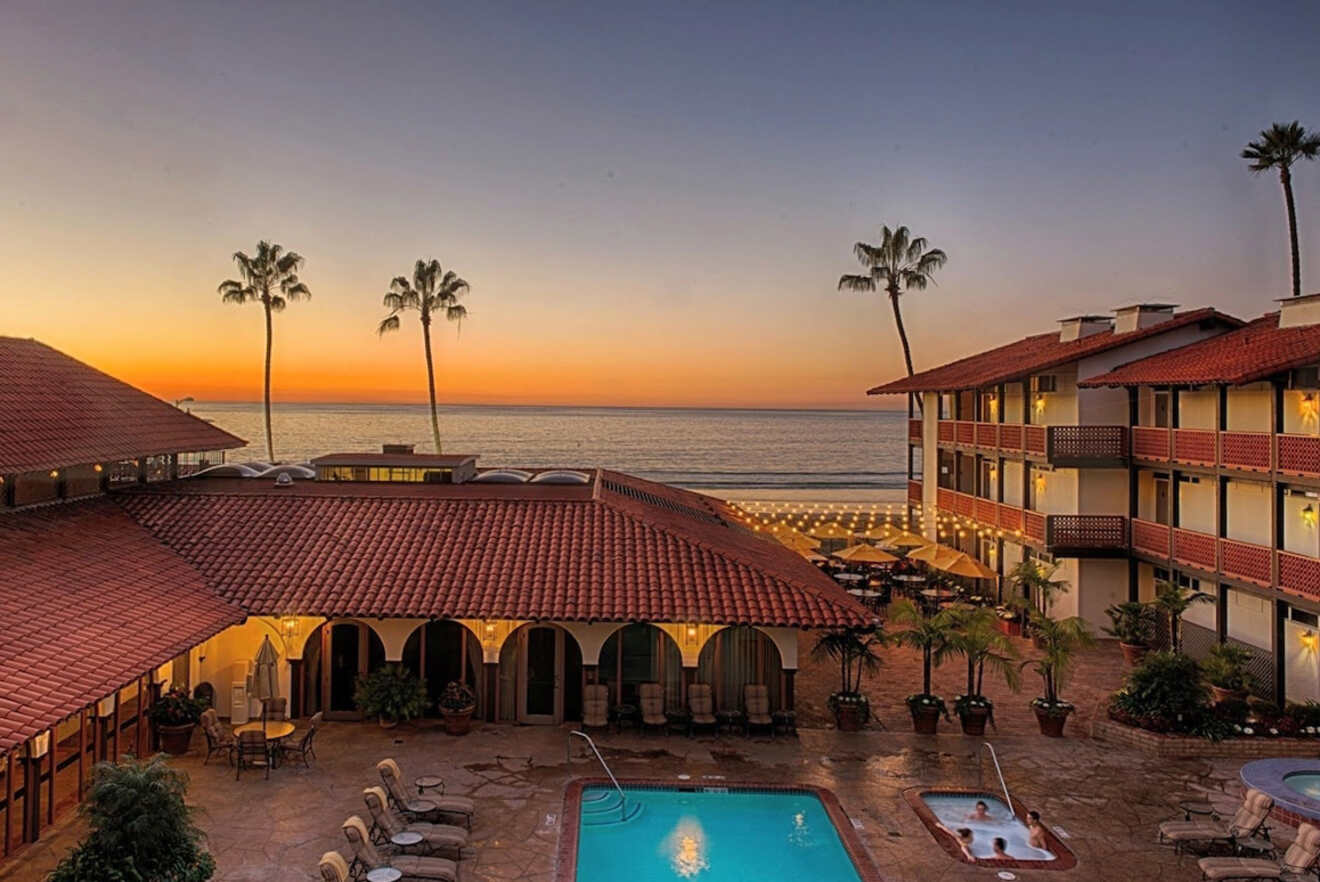 View of outdoor pool and hotel at sunset