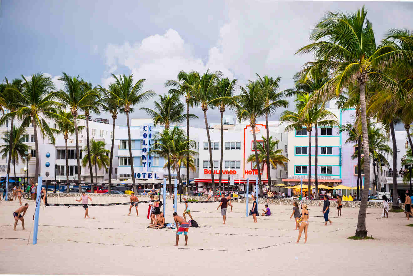 people on the beach with buildings in the background