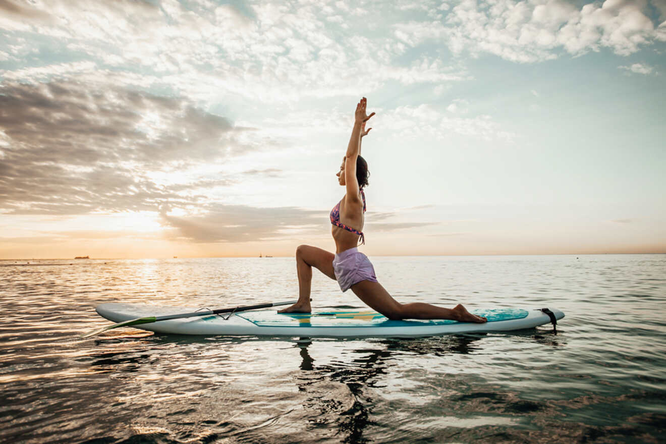 Woman practicing yoga on a paddle boat