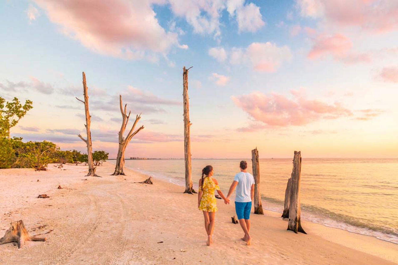 couple taking a walk on the beach at sunset