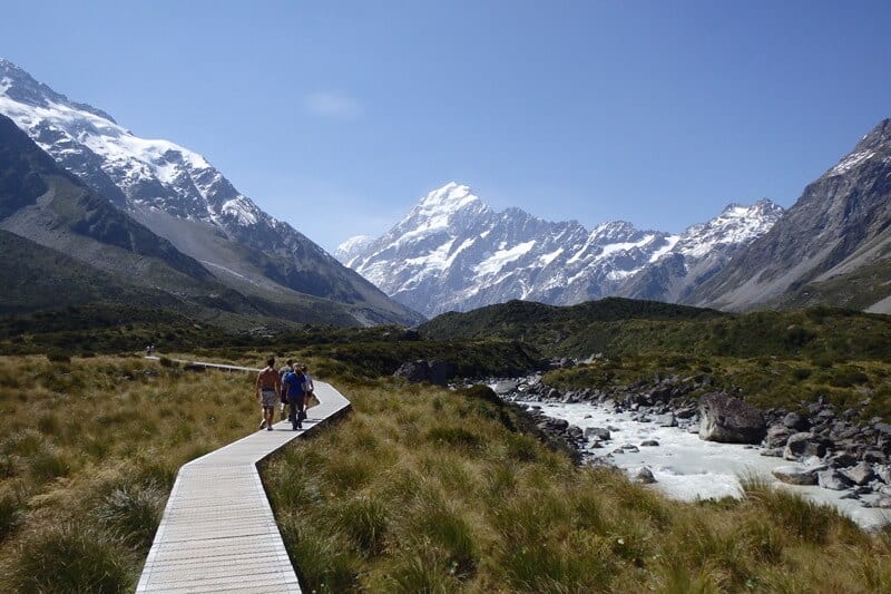 people walking on path in the mountain