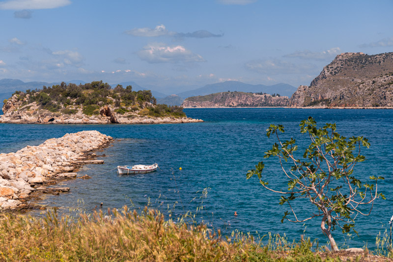 island close to shore and rocky pier