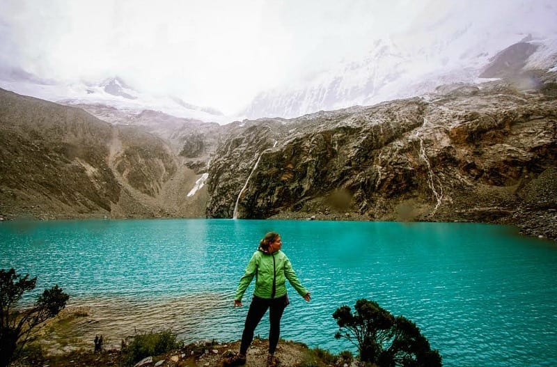 girl standing on edge of lake in Peru -s