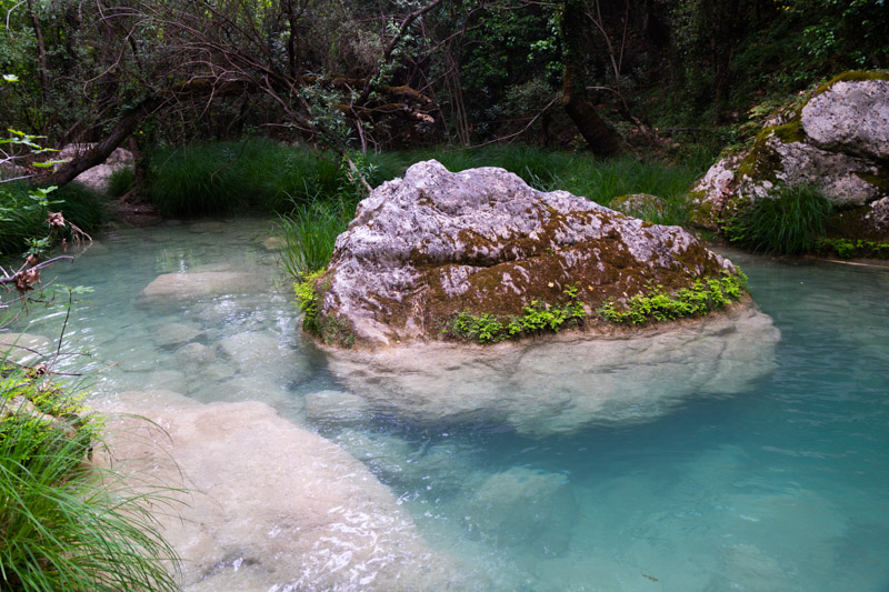 water flowing around a big rock in the river