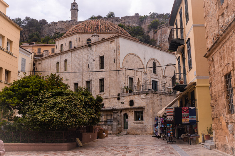 domed Vouleftiko mosque with church steeple in background on hill