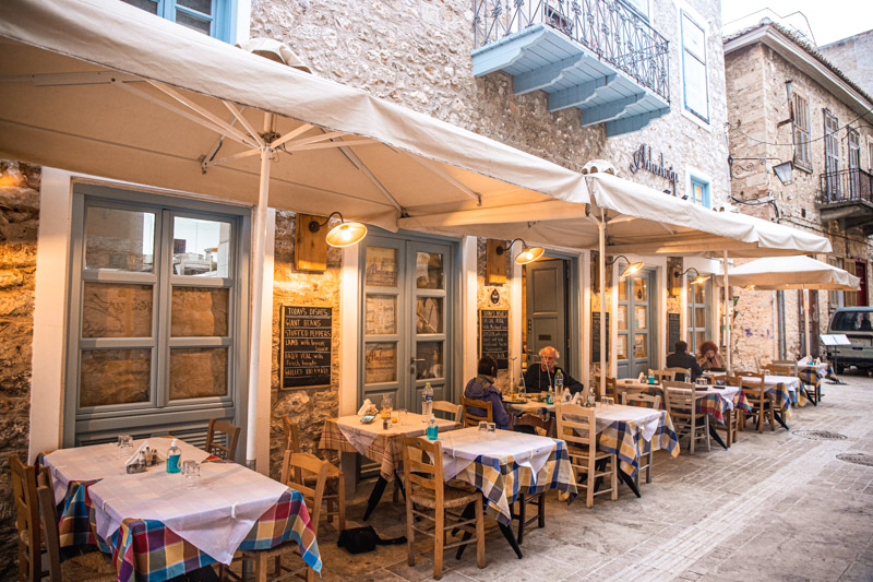 tables and chairs outside alaloum restaurant in alley