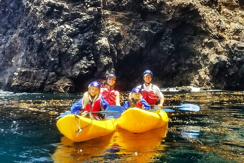 makepeace family  in kayaks smiling at camera