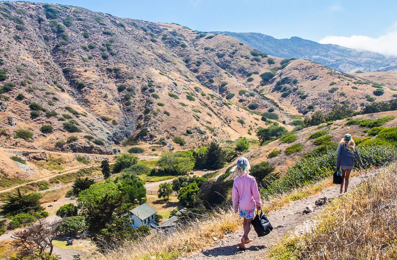 savannah and kalyra hiking on path with views of mountains and valleys