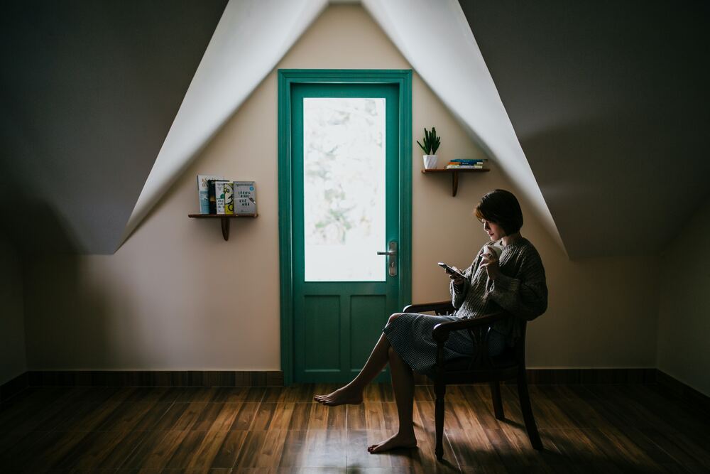 person sitting on chair reading phone