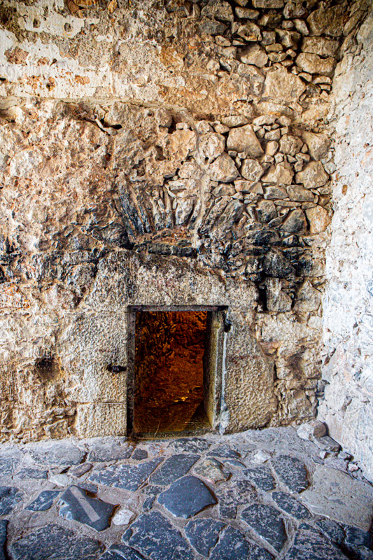 tiny entrance hole in brick wall to prison