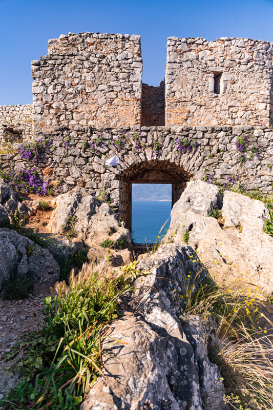 crumbling ruins of a brick gate with a window 