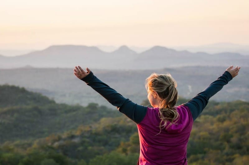 girl with arms wide open looking at view South Africa