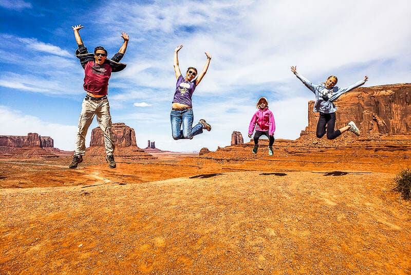 A family jumping in the air at Monument Valley Navajo Tribal Park